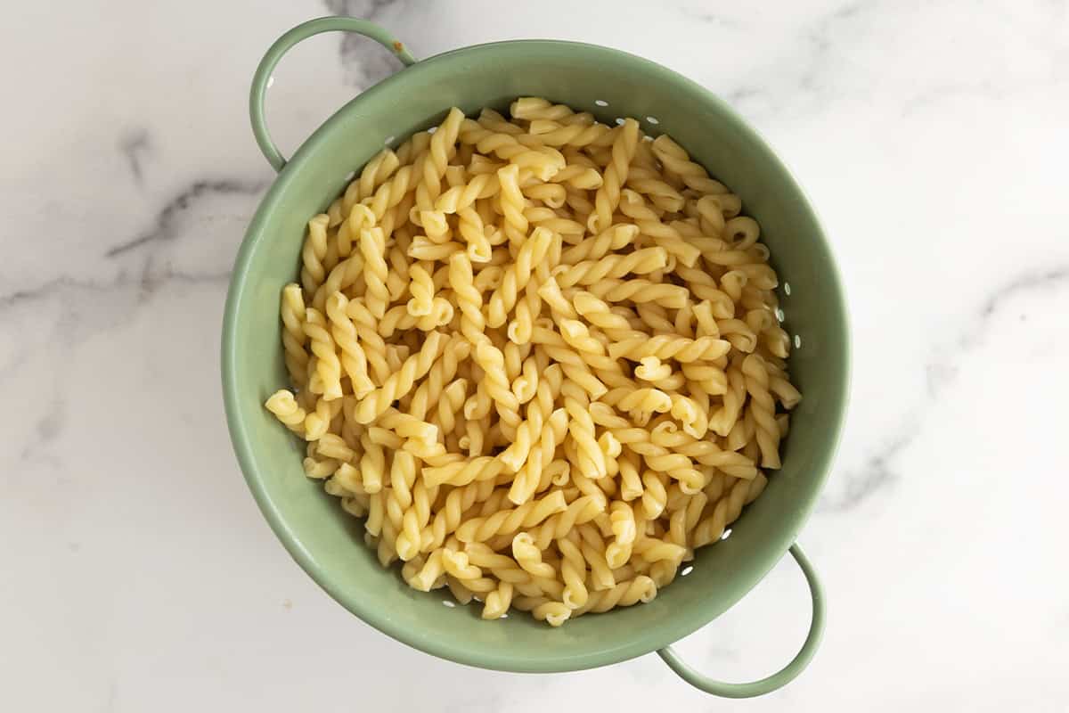 drained pasta in green colander. 