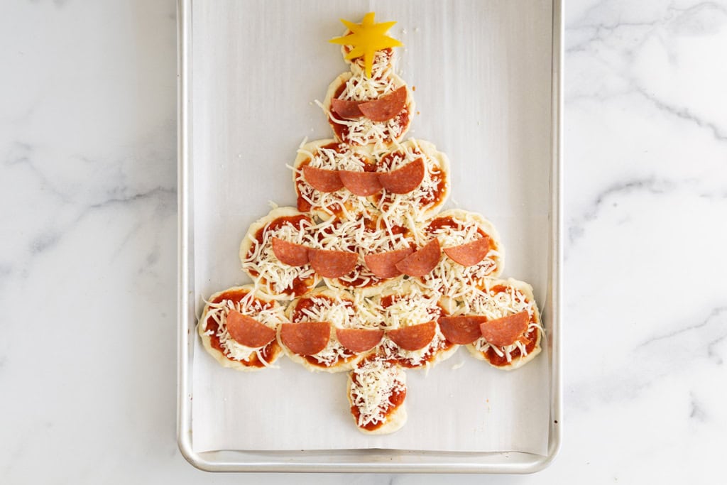 Christmas pizza on baking sheet before baking.