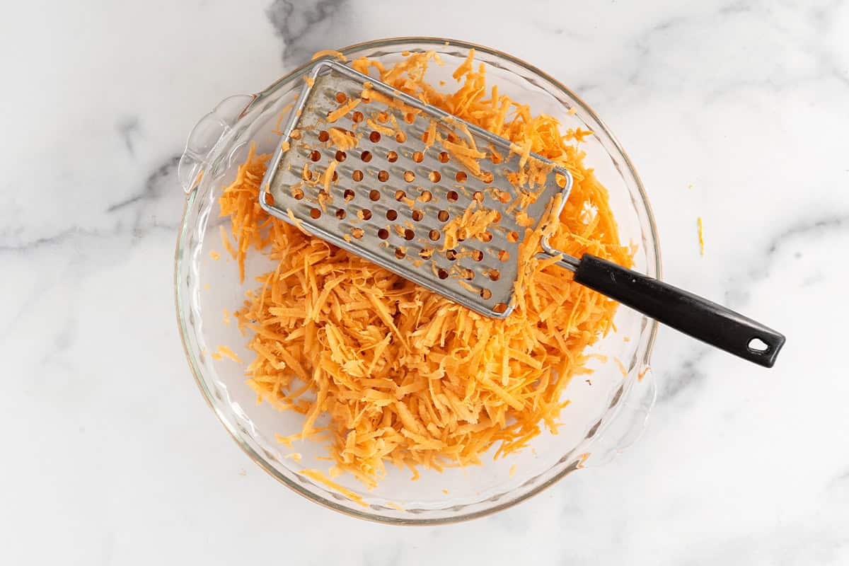 Shredding sweet potato for sweet potato fritters.