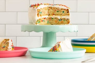 funfetti cake on teal cake stand.