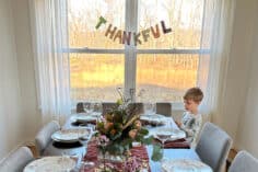 thankful banner behind table with boy.