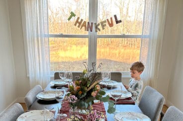 thankful banner behind table with boy.