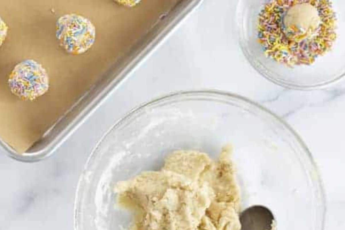 Sprinkle cookies being made and placed on cookie sheet.