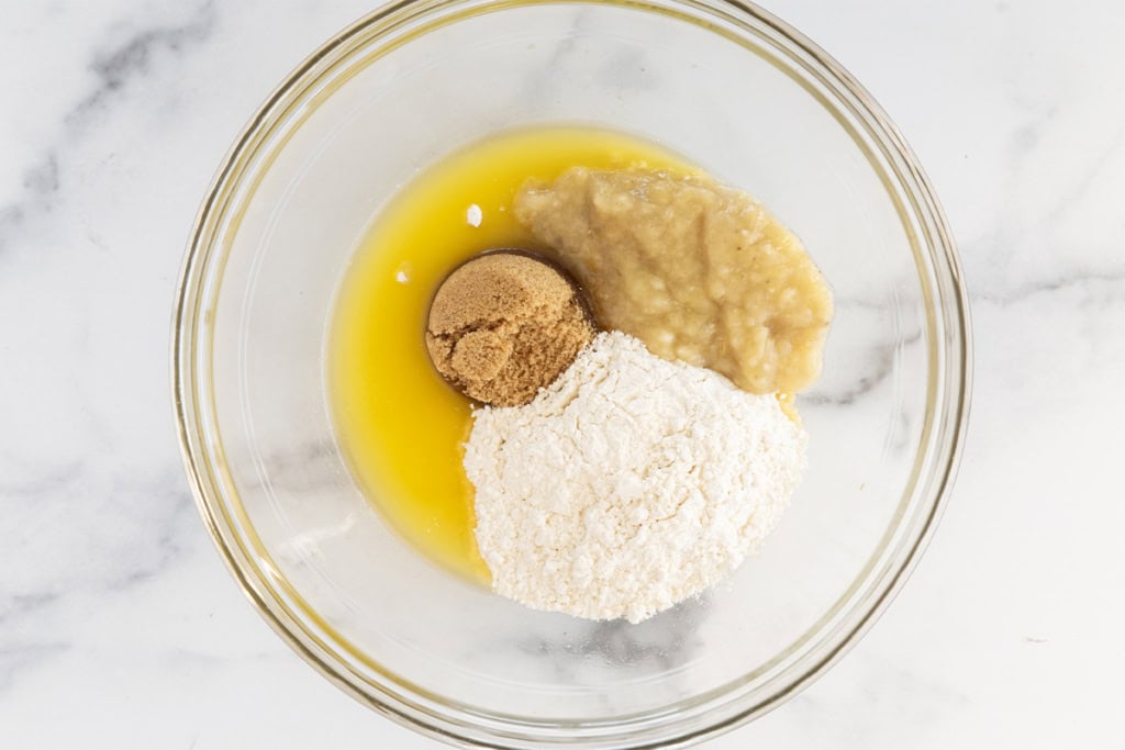 Ingredients for banana blondies in glass bowl before mixing.