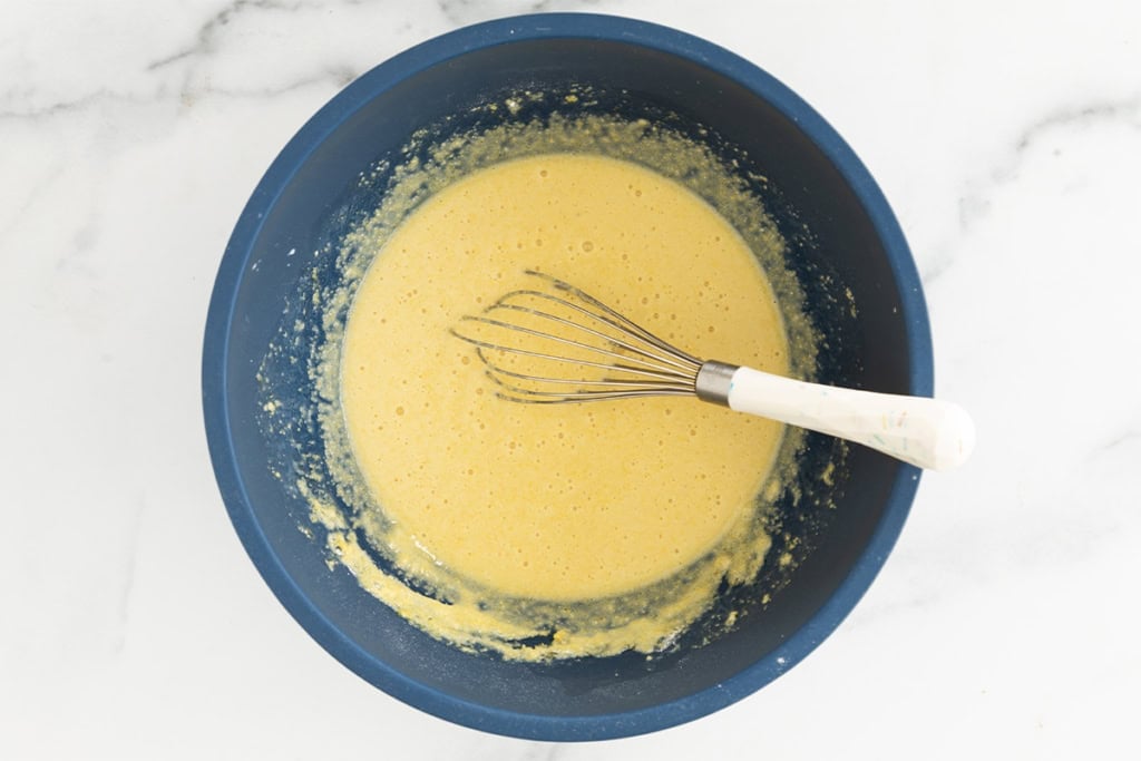 Ingredients for cornmeal pancakes in bowl after mixing.