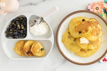 Cornmeal pancakes on two plates.