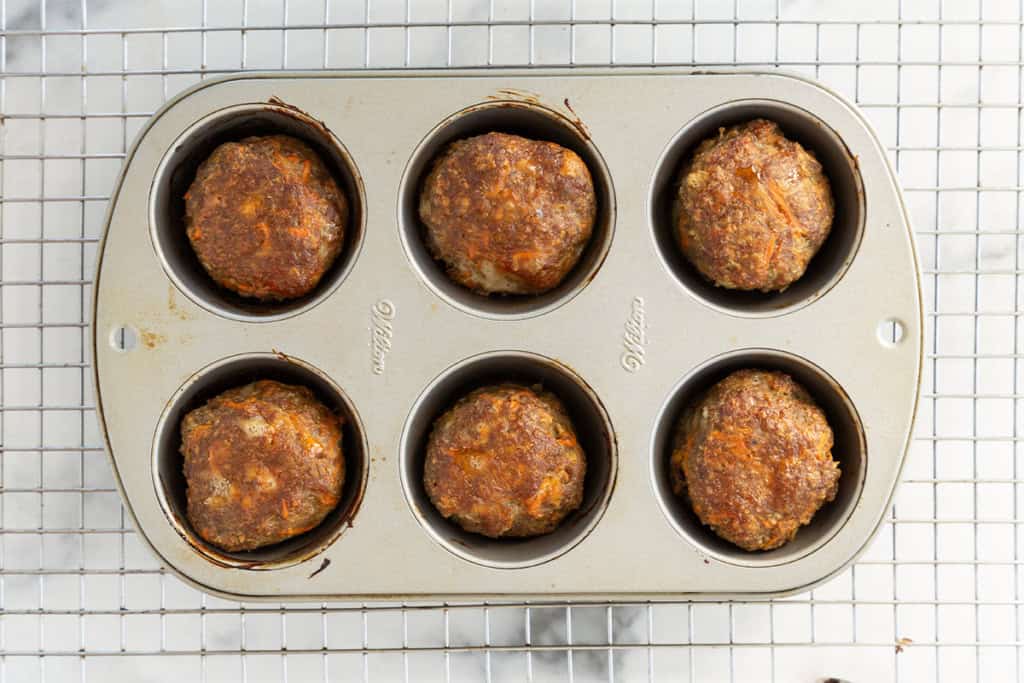 Mini meatloaves in muffin pan after baking.