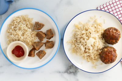 Mini meatloaves and sides on white plates.