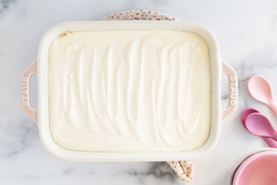 No-bake cheesecake in pan with spoons on side.