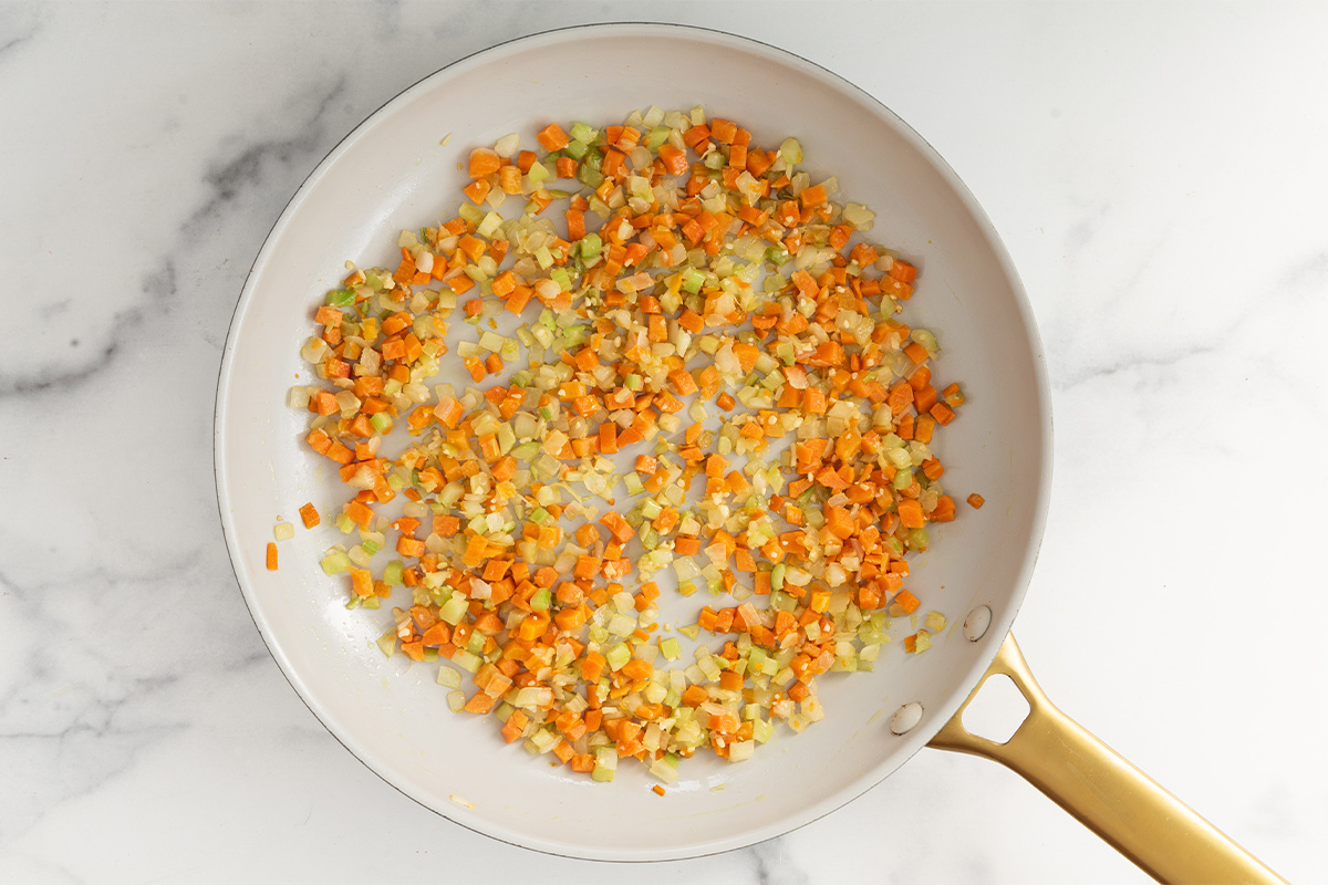 Carrots and onion in frying pan for baby bolognese.