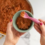 baby bolognese in bowl with spoon.