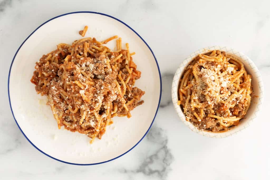 baby bolognese on pasta and on two plates.