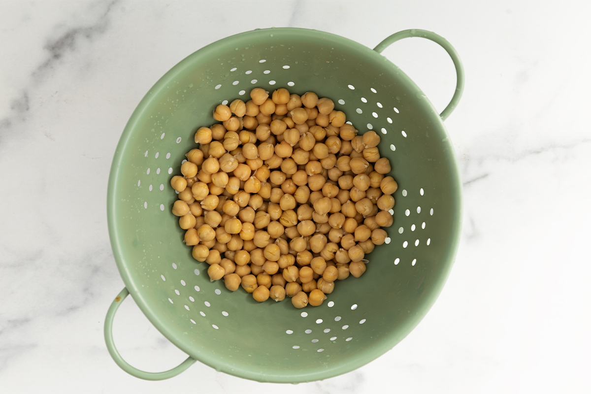 Chickpeas in strainer for baby hummus.