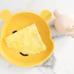 Baby omelette on yellow baby plate.