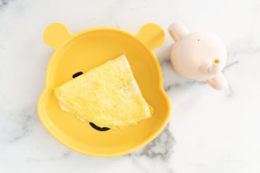 Baby omelette on yellow baby plate.