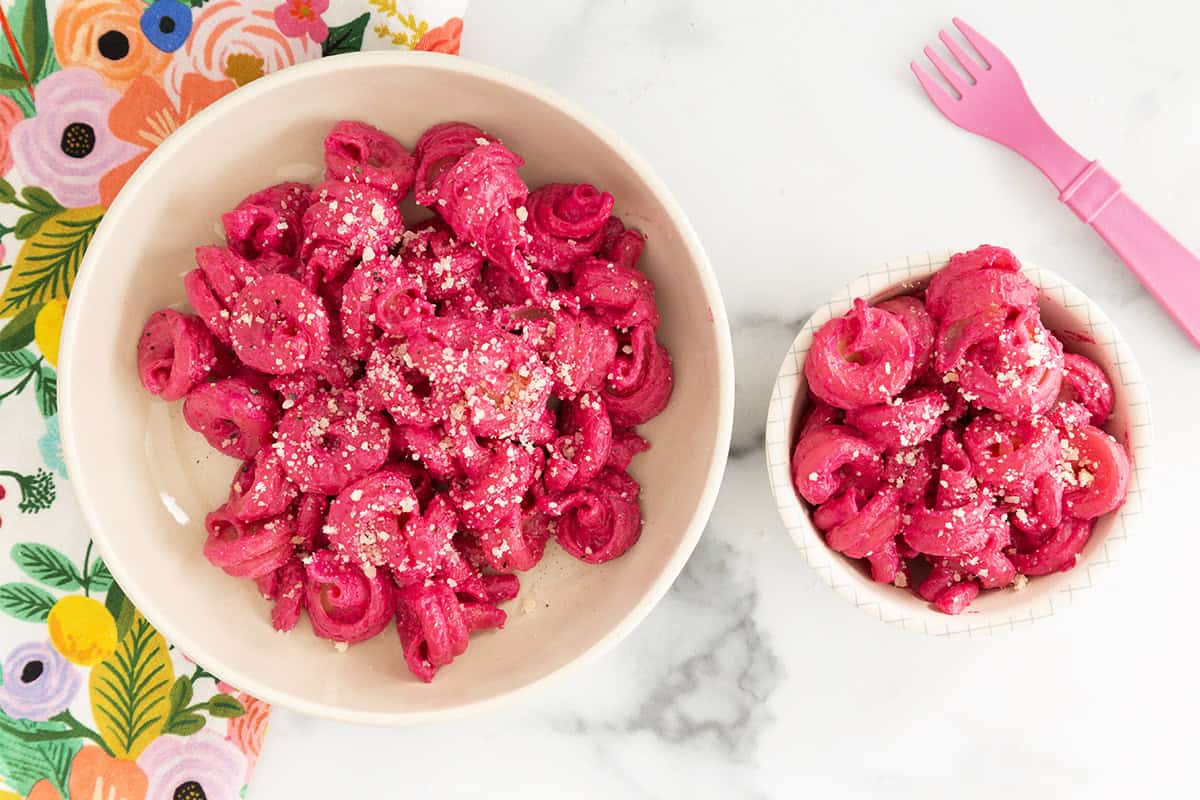 Beet pasta sauce on pasta in two bowls.