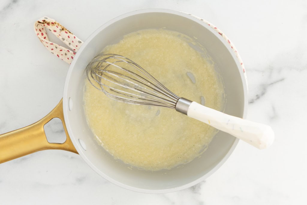 Flour and butter in pan for cheese sauce for pretzels.