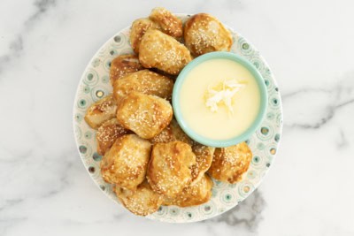 Cheese sauce for pretzels on plate with pretzels.