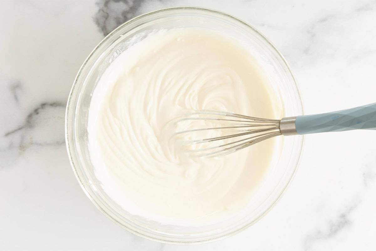 yogurt mixture for greek yogurt cheesecake in bowl.