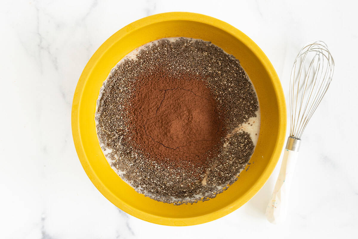 Ingredients in yellow bowl for Chocolate Chia Pudding before mixing. 