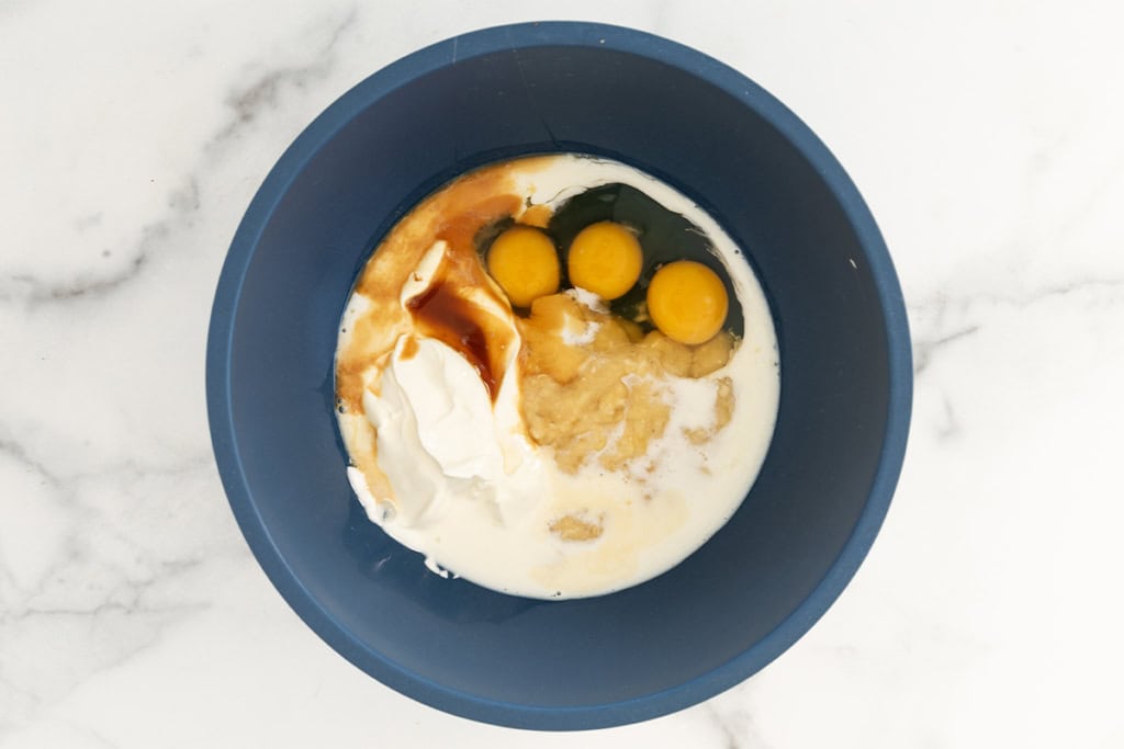 Ingredients for oatmeal protein pancakes in blue bowl.