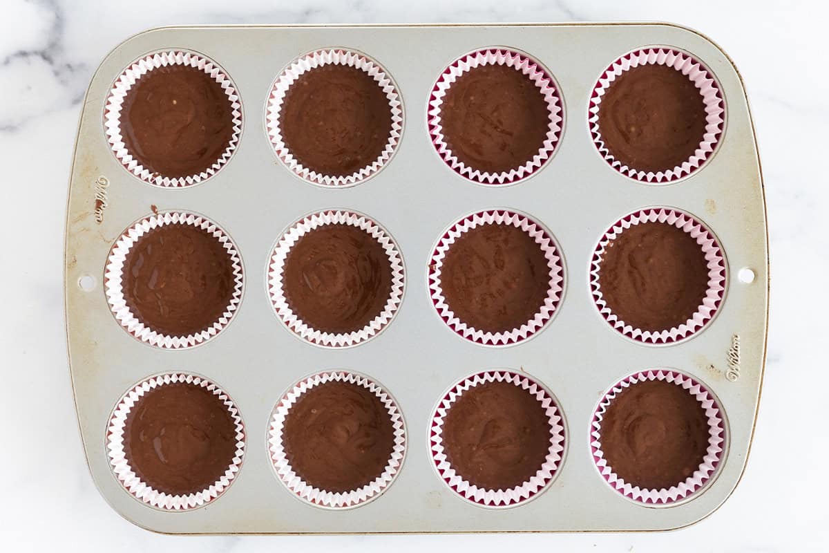 Vegan chocolate cupcakes in muffin pan before baking.