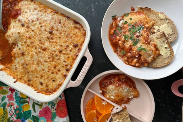 pizza beans on counter with plates.