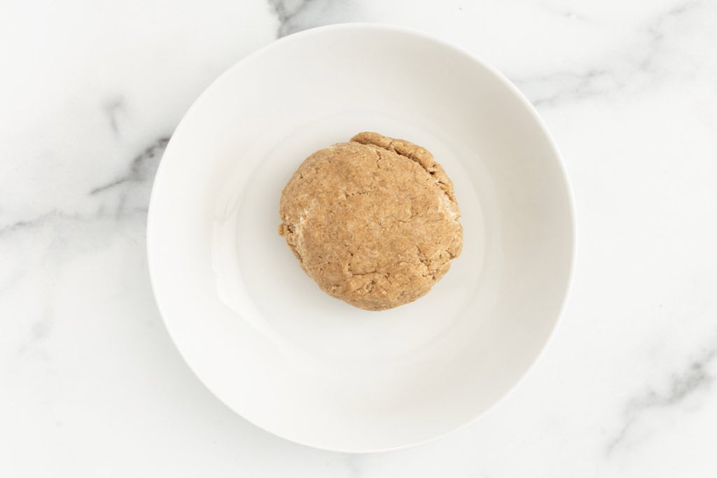 Dough for graham crackers in white bowl.