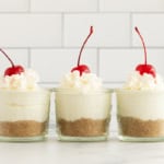 Three cheesecake cups on countertop.