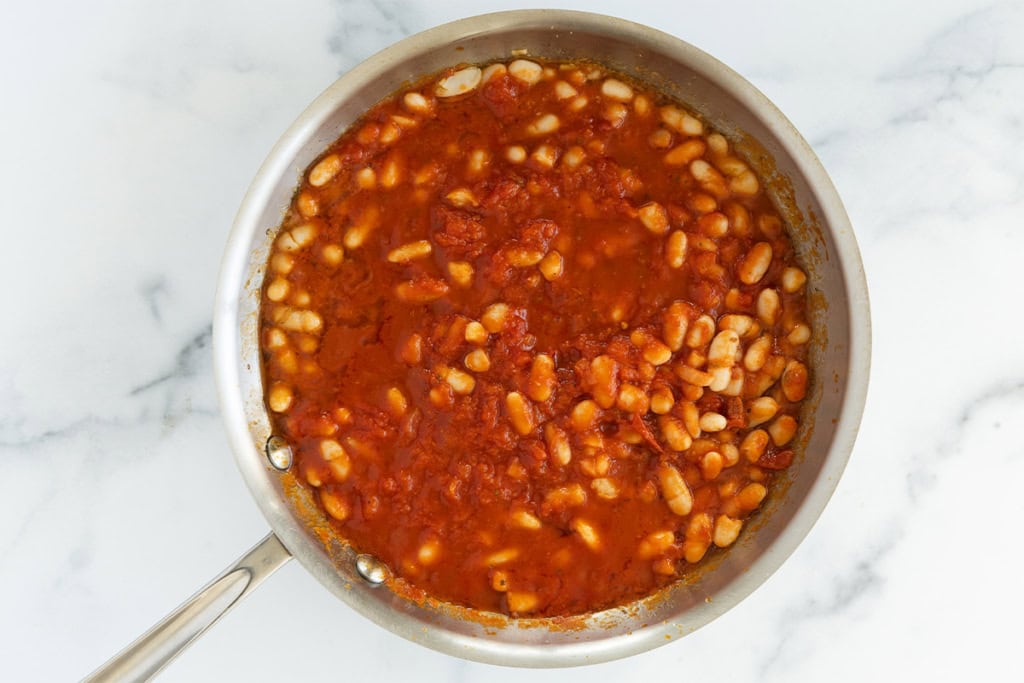 Beans and tomato sauce in pan for pizza beans.